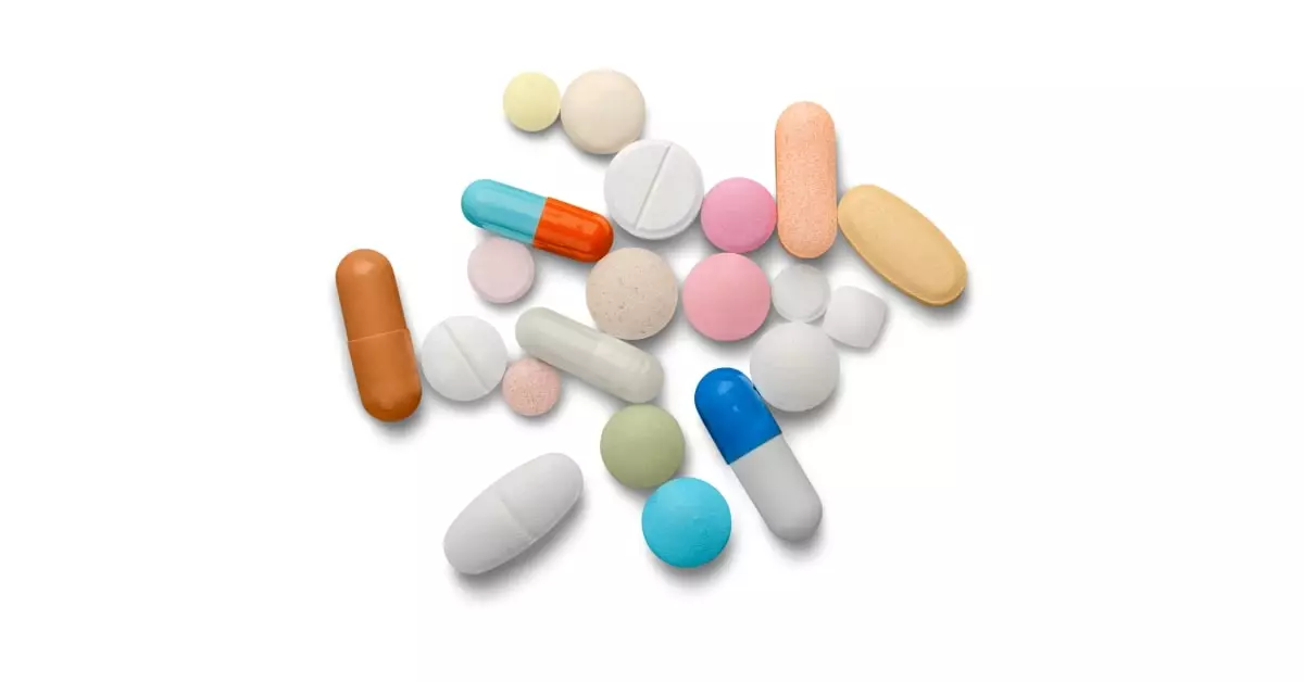 Assorted prescription pills including benzodiazepines scattered on a white background representing benzo addiction and substance misuse risks.