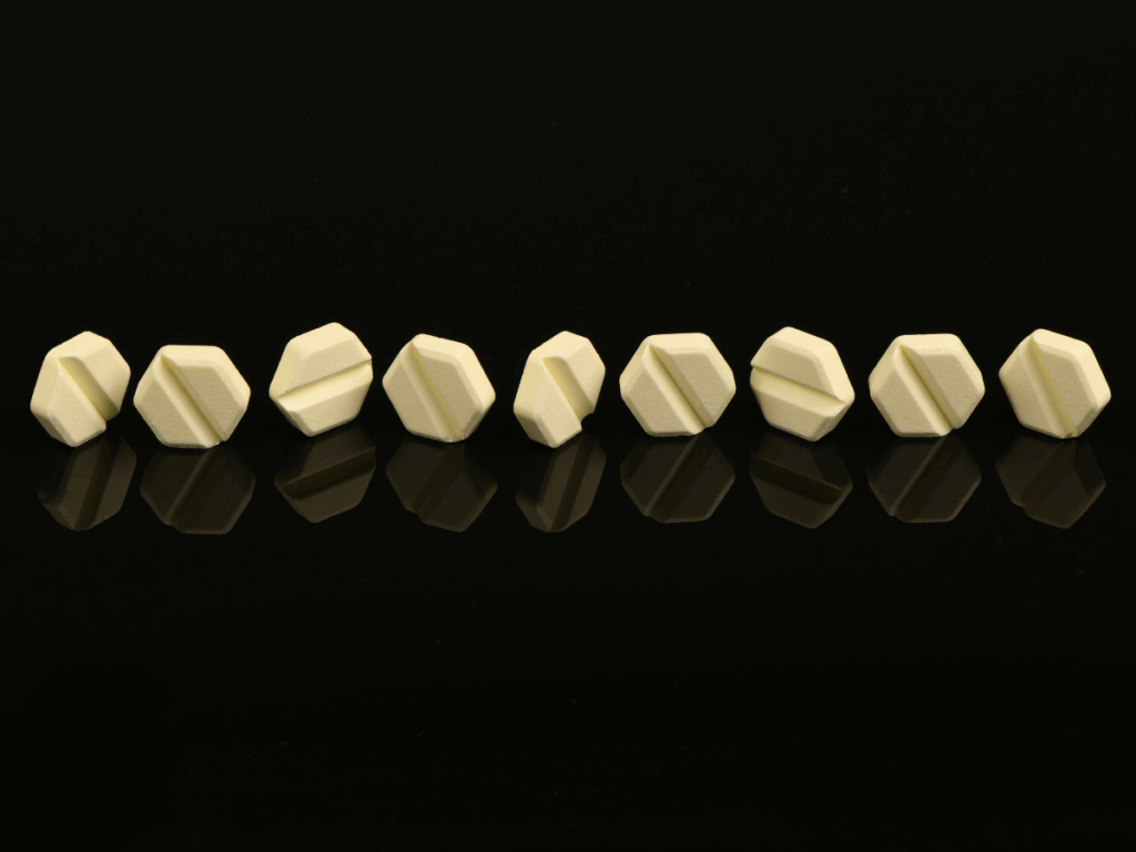 Benzodiazepine pills lined up on a black background symbolizing benzo addiction, dependence, and the need for professional treatment.
